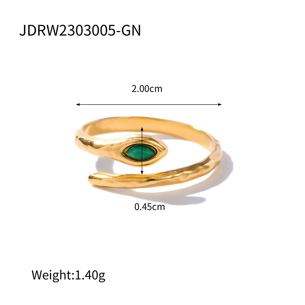 Gold ring with green gemstone and measurements on a white background