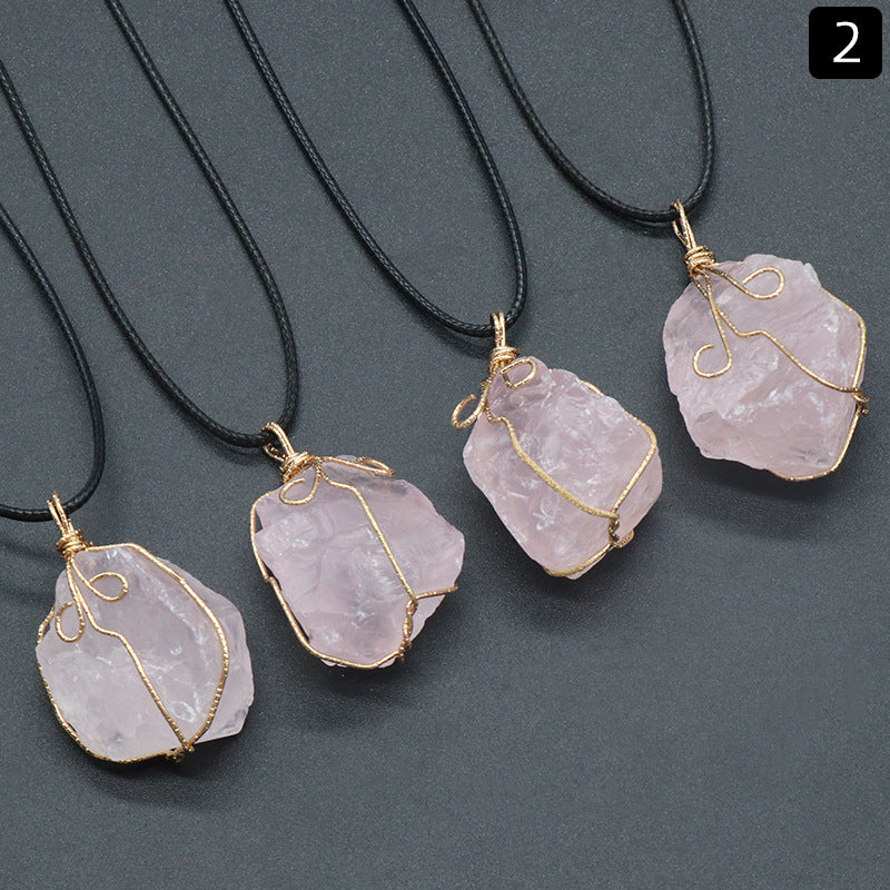 Four pink stone necklaces with gold wire wrapping on a gray background