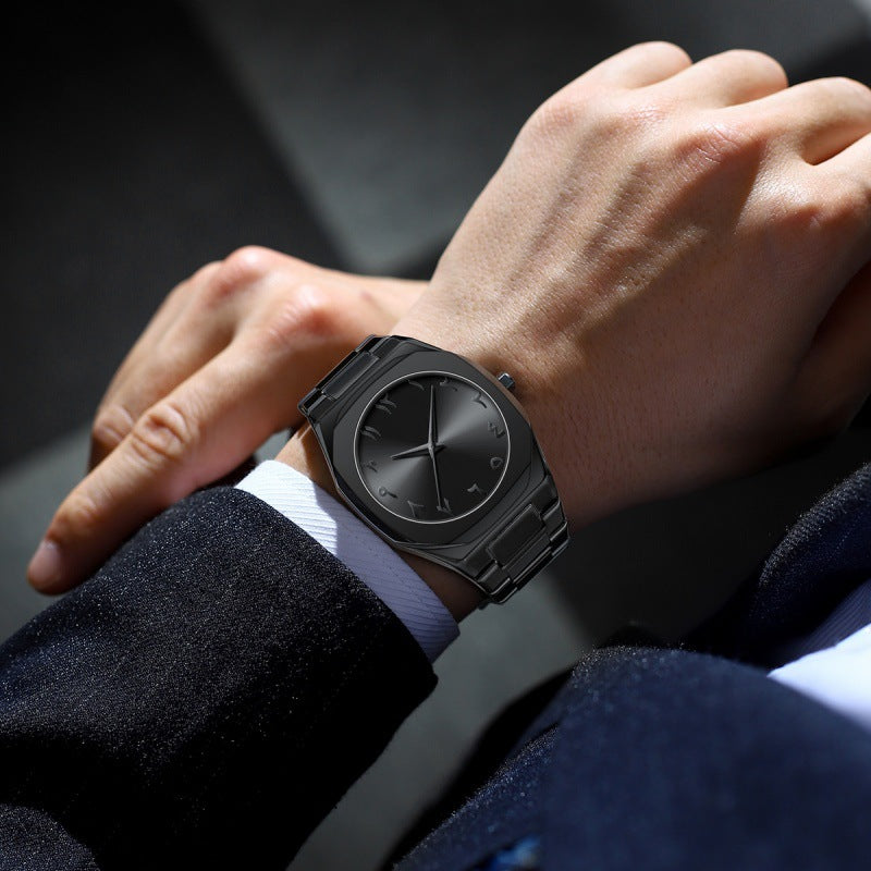 Person wearing a black wristwatch with a dark background