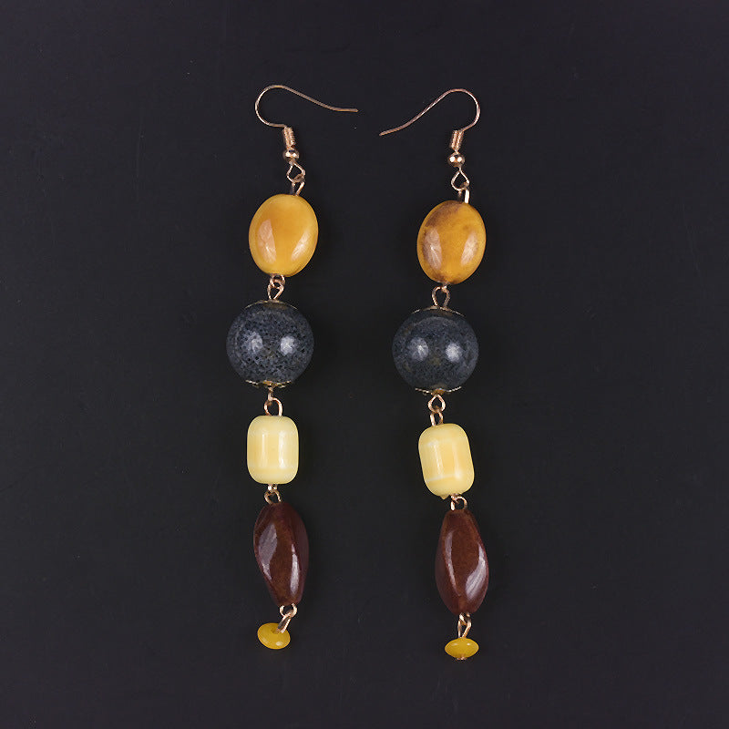 Pair of earrings with multicolored beads on a black background