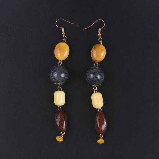 Pair of earrings with multicolored beads on a black background