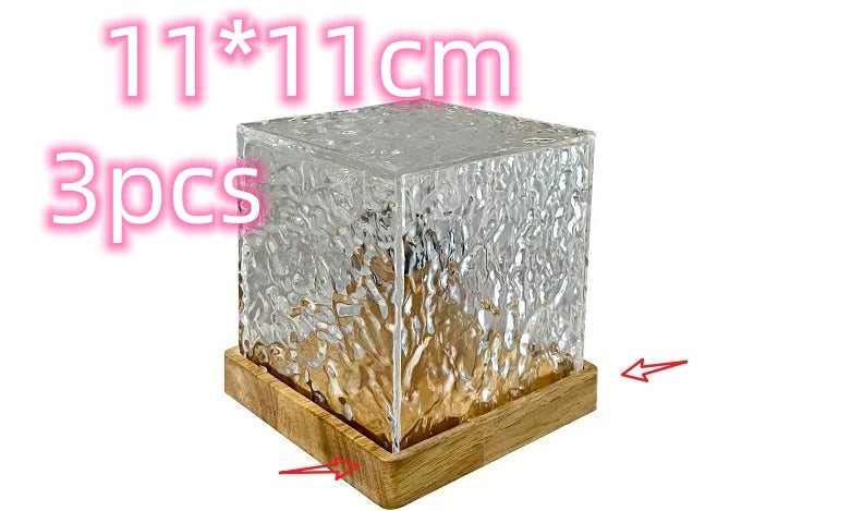 Transparent square glass block with wooden base, labeled '11*11cm 3pcs'.