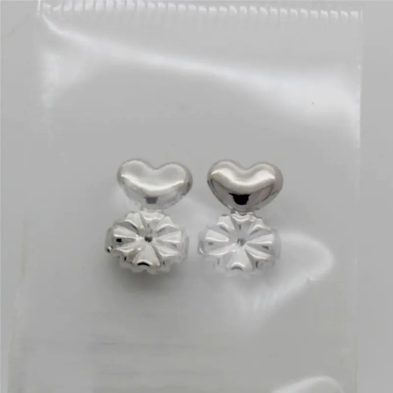 Silver heart-shaped earrings on a white background