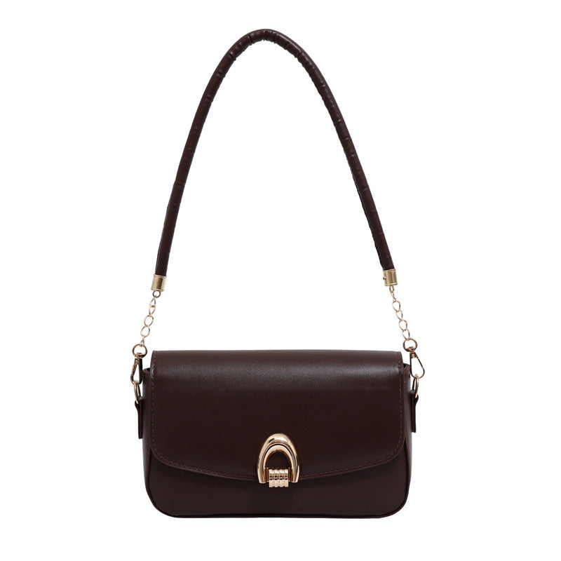 Brown handbag with a gold clasp on a white background