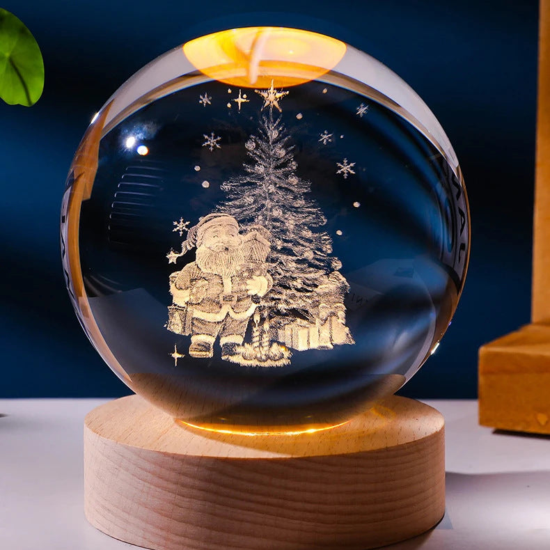 Crystal ball with Santa Claus and Christmas tree design on a wooden base against a dark blue background