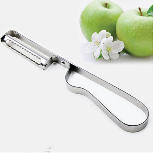 Metal apple peeler with green apples and a white flower on a white background