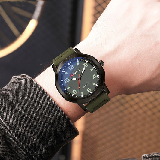 Green wristwatch on a person's wrist with a blurred background