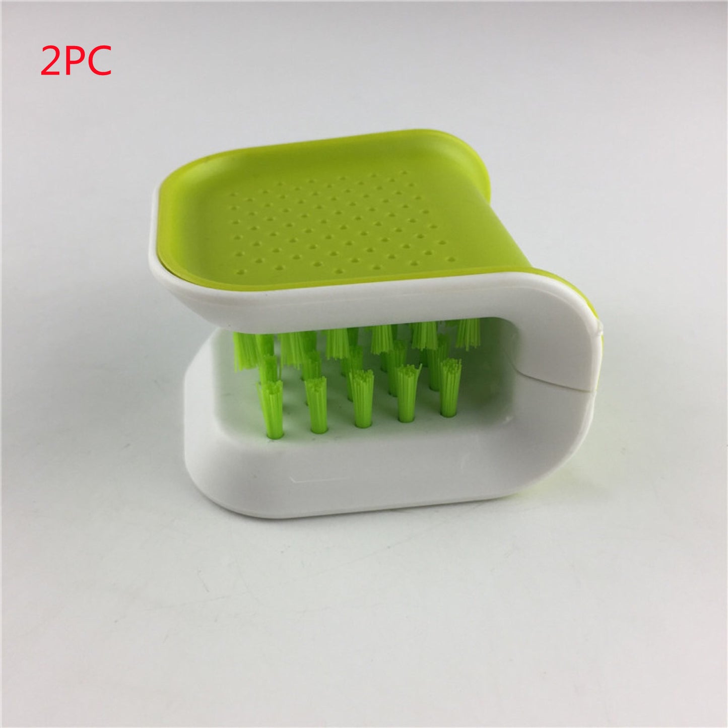 Green and white scrubber with a holder on a gray background
