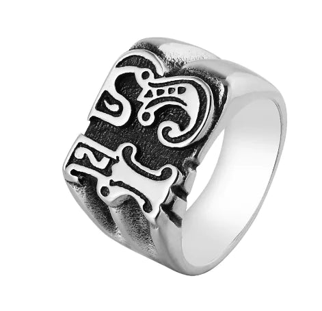 Silver ring with a detailed design on a white background