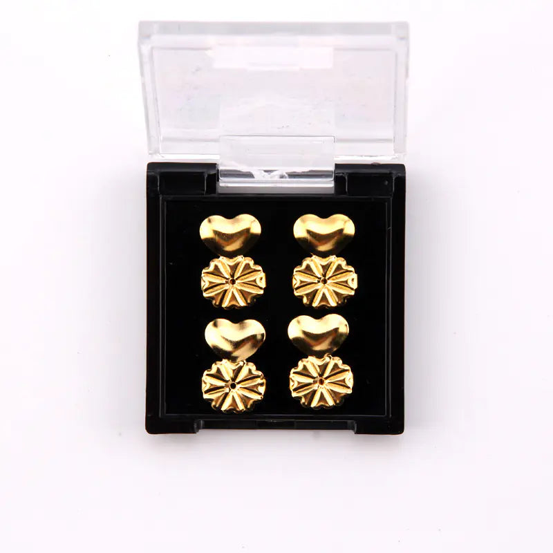 Set of gold heart-shaped earrings in a clear plastic case on a white background