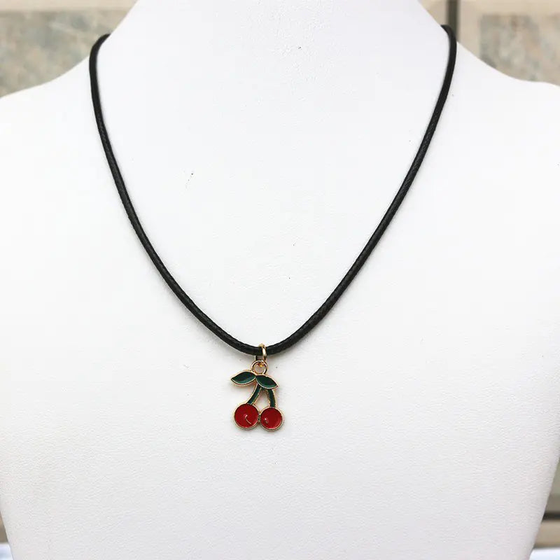 Necklace with cherry pendant on a mannequin