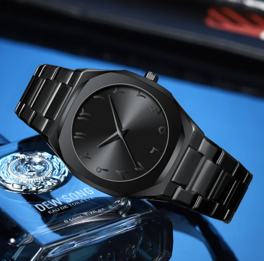 Black wristwatch on a reflective surface with a blurred background