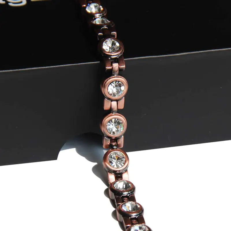 Bracelet with rose gold and silver beads on a black surface