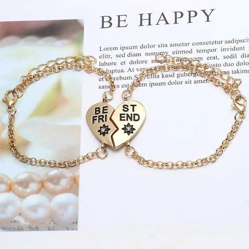 Gold bracelet with heart-shaped charms on a magazine page background