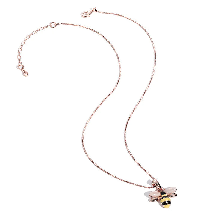 Rose gold necklace with a bee pendant on a white background