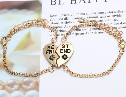 Gold bracelet with heart-shaped charms on a magazine page