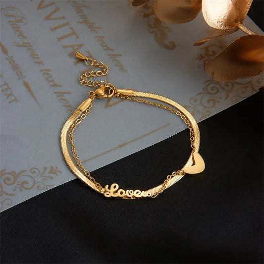 Gold bracelet with 'Love' engraving on a decorative background