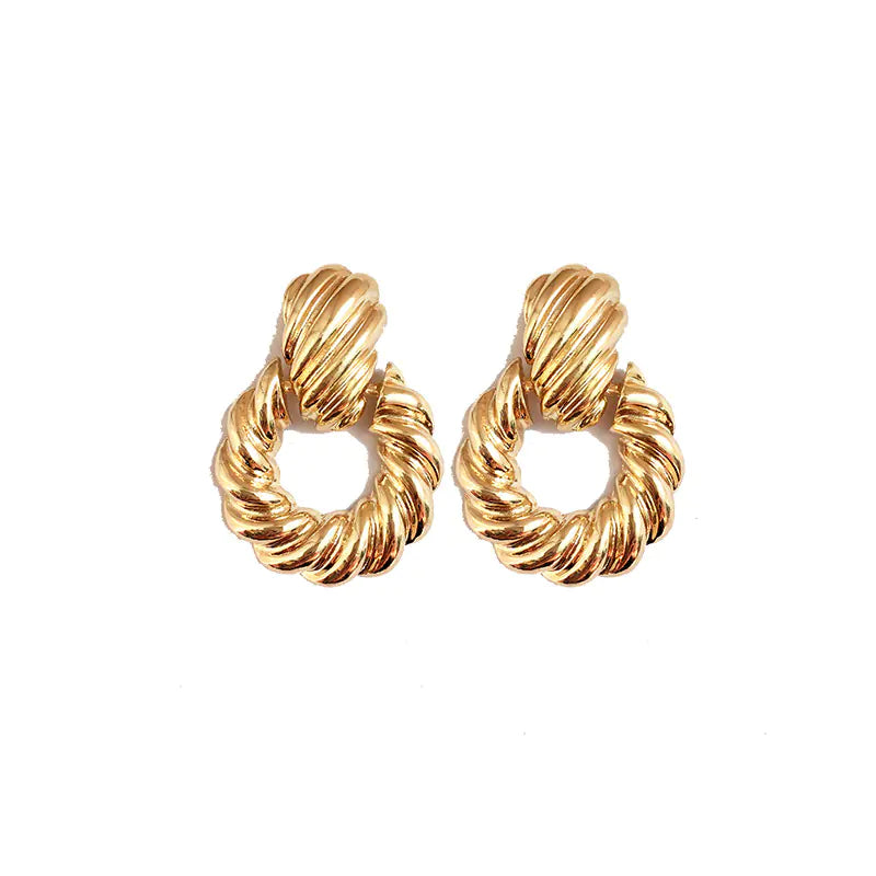 Pair of gold hoop earrings on a white background