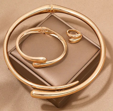 Gold bracelet on a beige fabric background