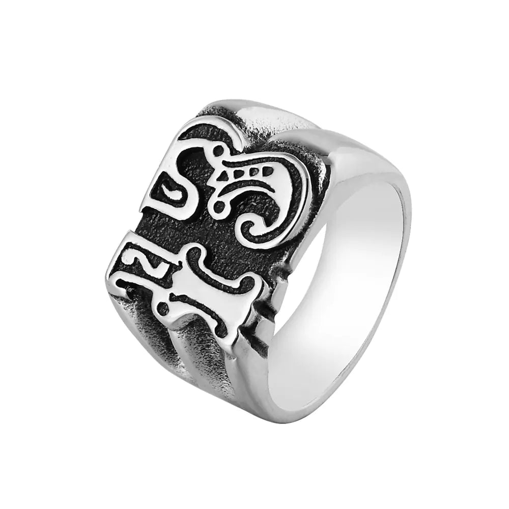 Silver ring with intricate design on a white background