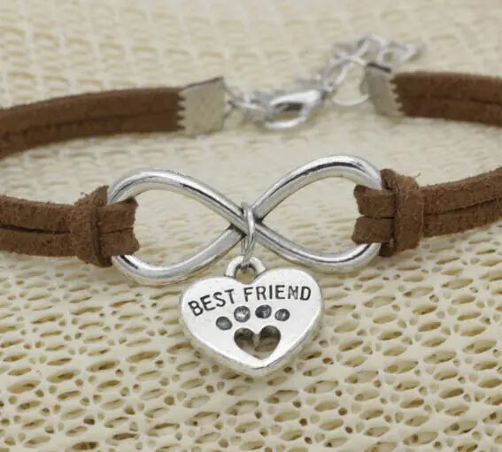 Bracelet with infinity symbol and 'Best Friend' charm on a textured beige background