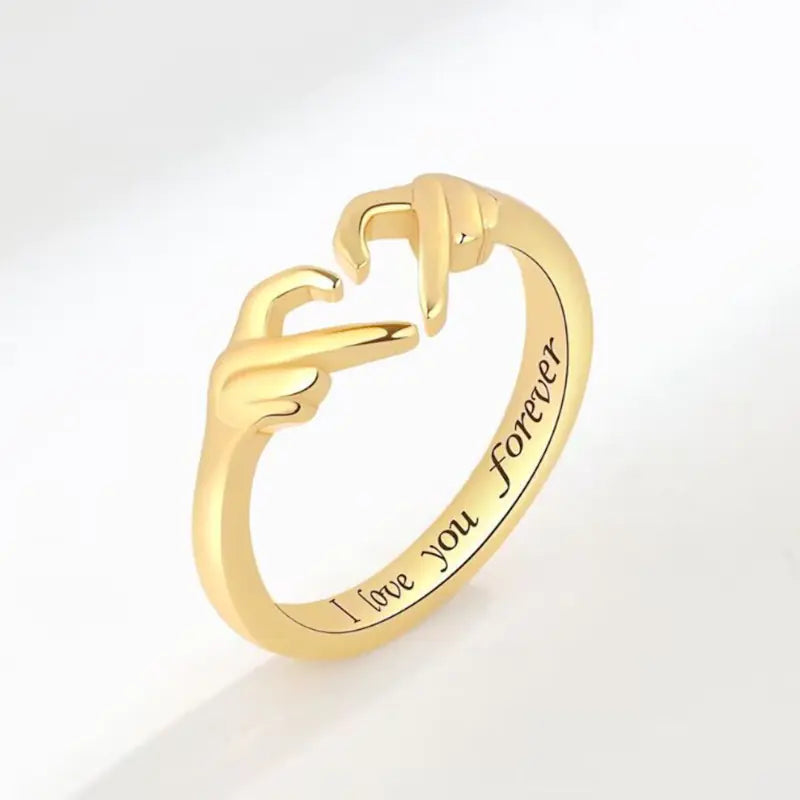 Gold ring with 'I love you forever' engraving on a white background
