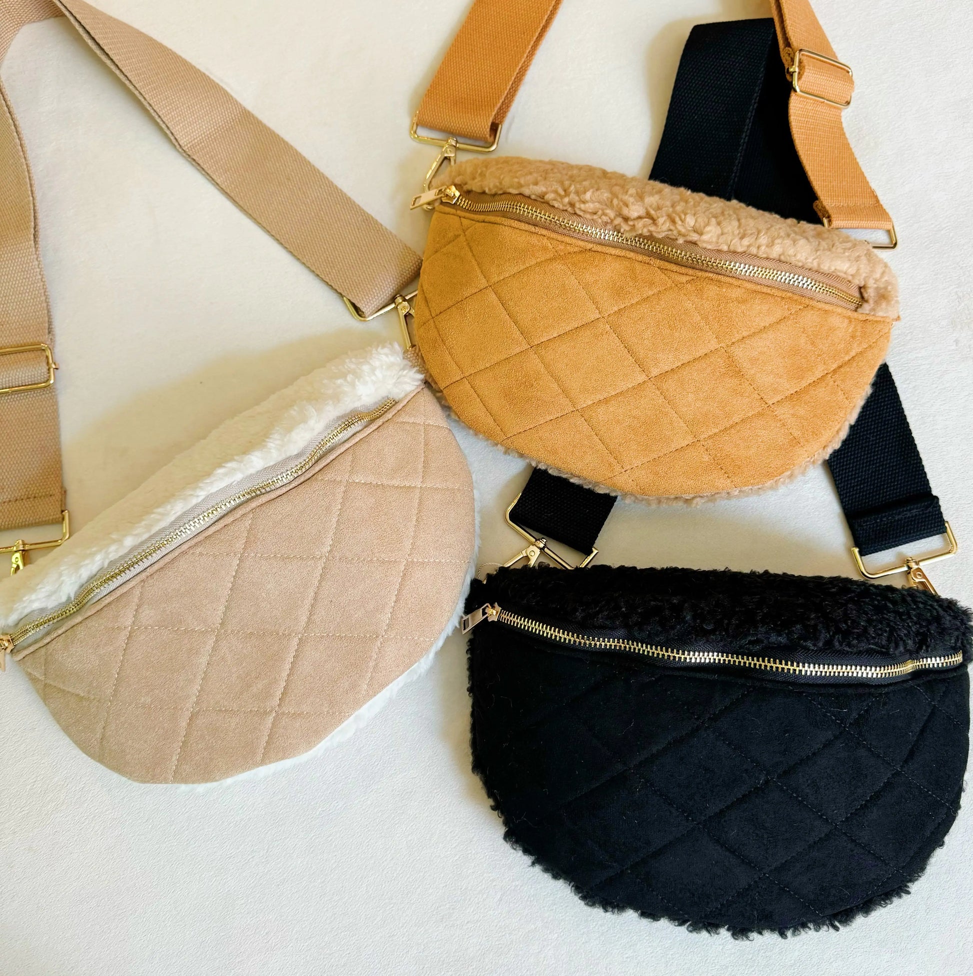 Three quilted fanny packs in beige, black, and brown on a light background