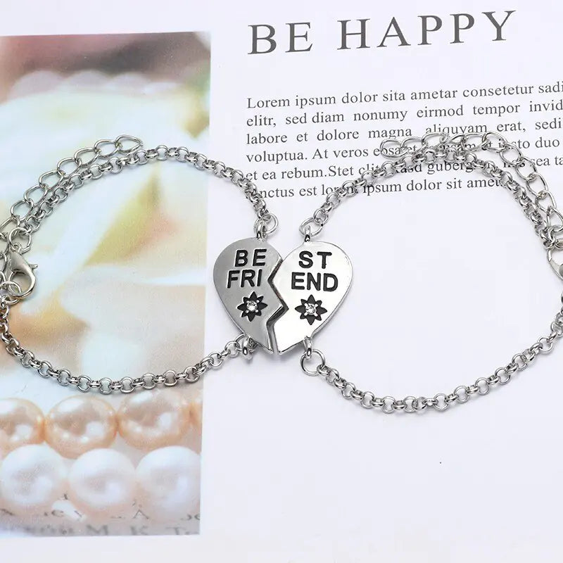 Silver bracelet with heart-shaped charms reading 'Best Friends' on a white background.